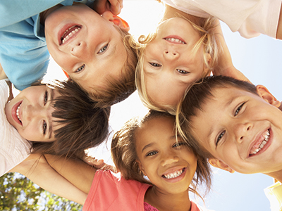 Children posing for a group photo, smiling and looking directly at the camera.